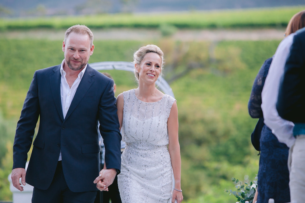 bride and groom walk up the aisle