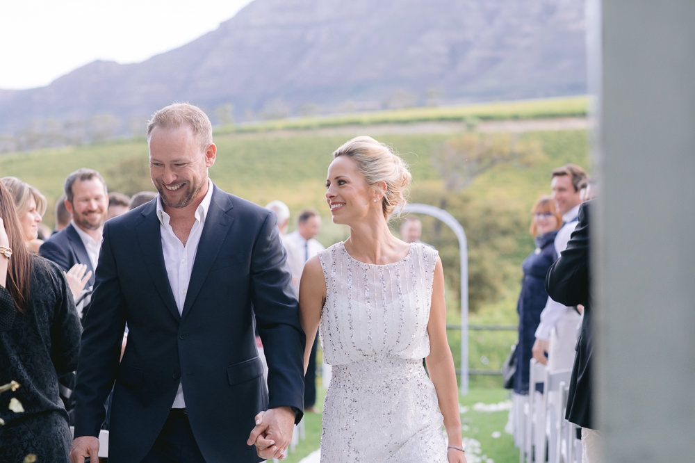 bridal couple walk down the aisle
