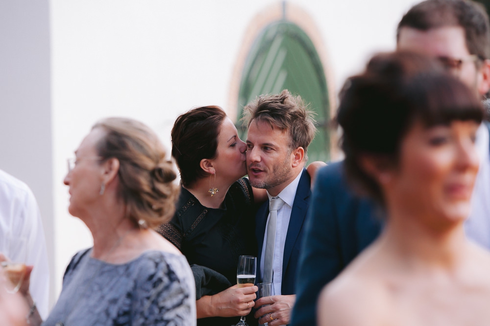 guests kissing at wedding