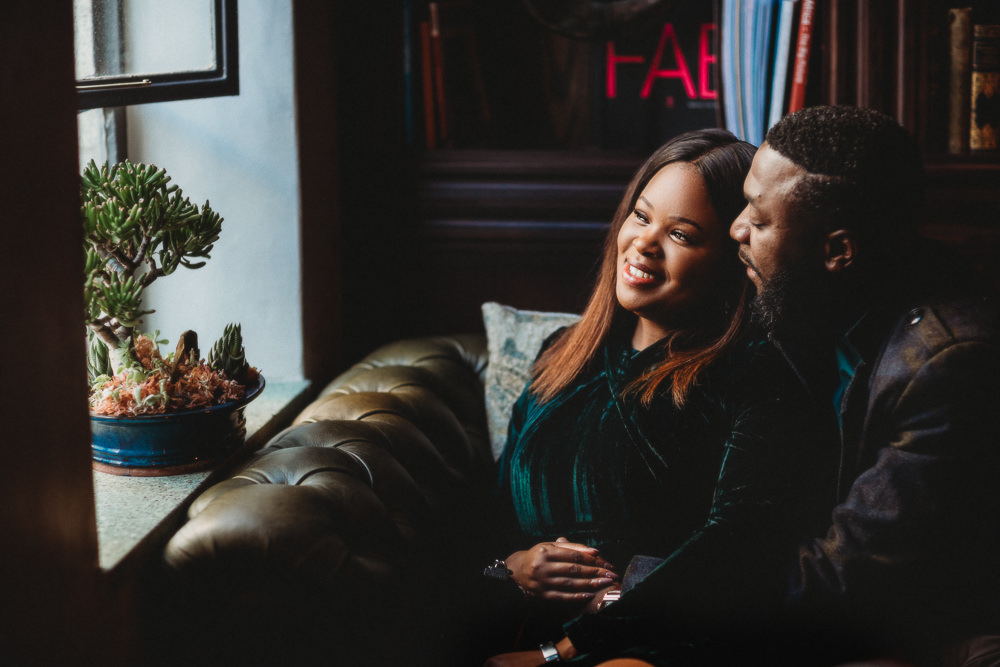 African couple enjoying cocktails at Gorgeous George for their engagement photoshoot with Jo-Ann Stokes Photography