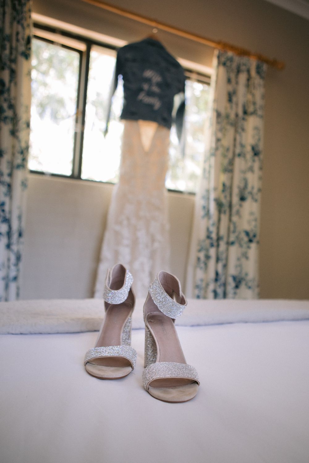 wedding shoes with dress in the background