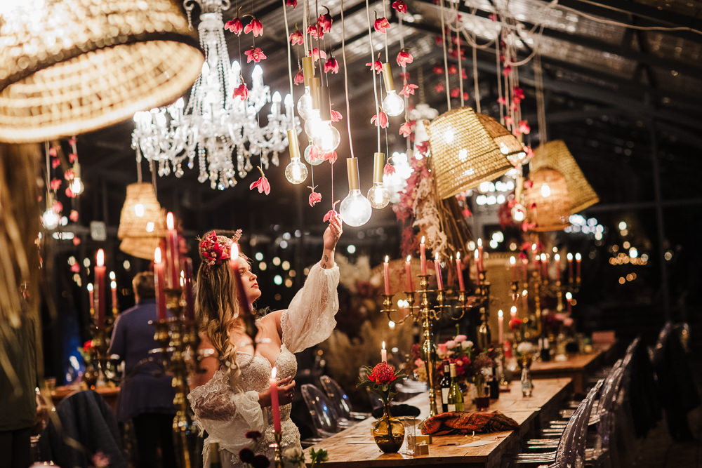bride admiring beautiful boho decor of her wedding at die woud